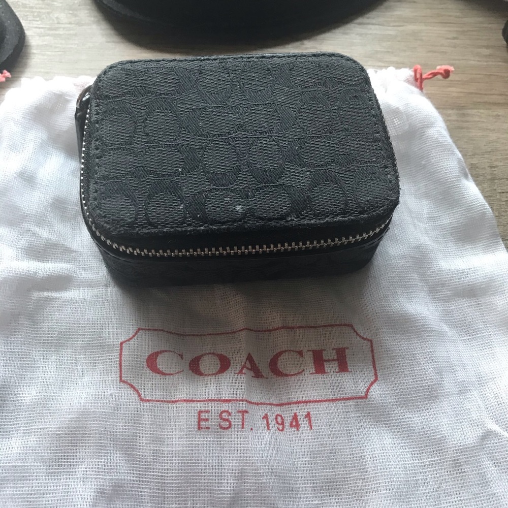 Black Coach pill carrier.